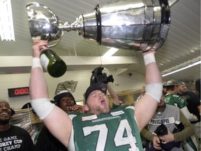 Defensive tackle Keith Shologan celebrates the Saskatchewan Roughriders' 2013 Grey Cup victory. Shortly thereafter, he was claimed by the Ottawa Redblacks in the CFL's expansion draft. He is to play for the Redblacks in Sunday's Grey Cup game against the Edmonton Eskimos.