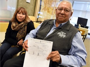 Shauneen Pete with her father Jacob Pete and a copy of his father Anthony's passes he needed to leave the reserve in Regina on Nov. 25, 2015.