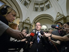 Premier Brad Wall speaks with reporters at the Legislative Building in Regina on Wednesday.