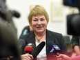 Retired social worker Linda Wacker speaks to reporters at the Legislative Building about the state of seniors care in the province.