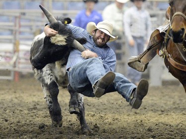 Jordan O'Neill, of Coldale Alberta, competes in Steer Wrestling at the Canadian Cowboys Association Finals Rodeo at the Canadian Western Agribition in Regina on Wednesday.