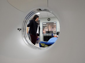 Dr. Andrea Gourgaris, a radiologist at Radiology Associates of Regina, demonstrates a CT scanner in Regina on Nov. 30, 2015.