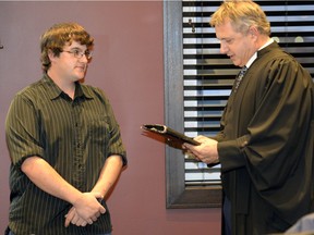 Jeff Poissant, left, is sworn in as new reeve of the RM of Sherwood by Steven Schiefner, official administrator, at the Nov. 4, 2015 council meeting.