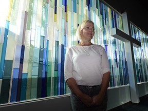 Glass artist Janice Stefan stands by here work in the Living Hope Alliance Church in Regina.