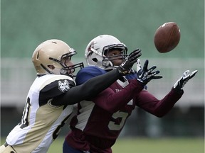 Regina Thunder defensiveback Menedum Menegbo (#5) nearly intercepts a pass intended for Edmonton Huskies widereceiver Dylan Stanton (#80) during a game held at Mosaic Stadium in Regina, Sask. on Sunday Oct. 11, 2015.