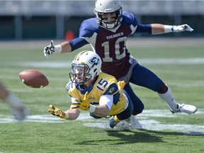 Regina Thunder defensive back Marcus Hall (#10) is caught behind Edmonton Wildcats receiver Brandon Olson (#15) who made this reception during a game held at Mosaic Stadium in Regina, Sask. on Sunday Aug. 23, 2015. (Michael Bell/Regina Leader-Post)