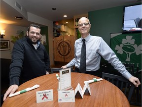 REGINA,Sk: NOVEMBER 10, 2015 --Shannon's pub is one of a handful of Regina businesses that will be placing "tent cards" on tables to help raise funds and awareness for AIDS and HIV awareness. On Tuesday, Brian Wiens (right), executive director for AIDS Programs South Saskatchewan, introduced the program at the Saskatchewan Legislature. Weins and Shannon's pub owner Thomas Shannon pictured at the pub November 10, 2015. BRYAN SCHLOSSER/Regina Leader-Post