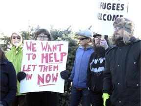 A small group of protesters in front of the Saskatchewan Legislature calling for Brad Wall to reverse his request that the federal government pause its plan to bring 25,000 Syrian refugees to Canada by the end of the year.