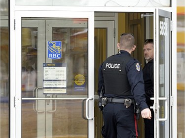 Regina Police service officers enter the RBC on the 5800 block of Rochdale Boulevard to investigate an incident on Tuesday.