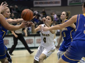 University of Regina Cougars guard Avery Pearce (4) heads into a forest of arms during a Canada West women's basketball game against the University of Lethbridge Pronghorns on Friday.