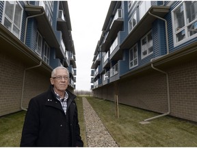 John Labatt standing between two condominium buildings in east Regina on Nov. 24, 2015. Labatt wants to warn Regina residents about how close developers are allowed to build condominium buildings.