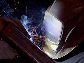 Jordan Taylor works on a spouting stand for an inland grain terminal at the shop at JR's Welding in Regina. Average weekly earnings increased 0.5 per cent to $984 in September.