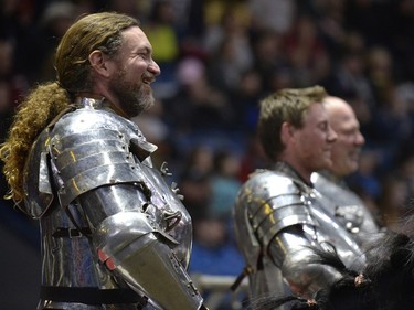Shane Adams, left, a member of the Knights of Valour Jousting Troupe, laughs while watching the gauntlet at Agribition at the Brandt Centre in Regina, Sask. on Saturday Nov. 28, 2015.