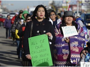 Shayla Williams, centre, walks with her mother Nicole, right, during a My Life Matters walk on Albert St. in Regina, Sask. on Saturday Nov. 7, 2015. (Michael Bell/Regina Leader-Post)