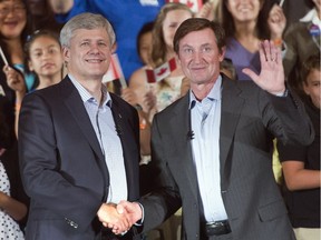 Conservative Leader Stephen Harper shakes hands with Wayne Gretzky during a campaign event in Toronto on Friday, Sept. 18, 2015.