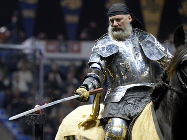 Tim Tobey, a member of the Knights of Valour Jousting Troupe, slices the very top of an apple with a sword during the gauntlet at Agribition at the Brandt Centre in Regina, Sask. on Saturday Nov. 28, 2015.