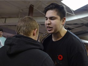 Timothy Poitras-Kay, right, who goes by the rap name "Cataclyzm" competes in a freestyle exhibition match against Jessie "Jus Rite" Rebrinsky, left, during Straight Outta Regina, a rap battle held at 306 Shop in Regina, Sask. at 9:06 p.m. on Saturday Nov. 21, 2015. While each combatant takes turns to rap at the other, they also posture to intimidate or humour, trying to get support from the crowd.