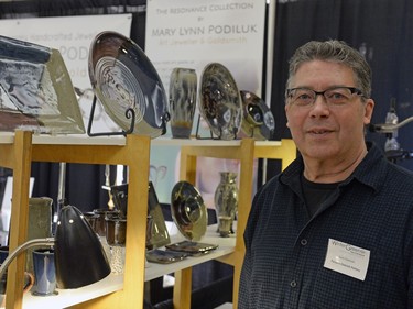 Zach Dietrich of Parsons Dietrich Pottery stands near his creations at Wintergreen Fine Craft Market in Regina, Sask. on Saturday Nov. 21, 2015. The annual event is organized by the Saskatchewan Crafts Council, which celebrates its 40th anniversary this year.