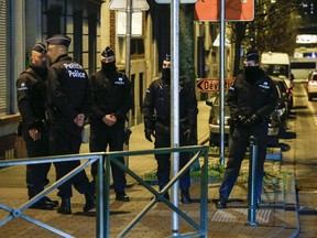 Police officers conduct new searches linked to Paris terrorist attacks, on December 30, 2015, in Molenbeek, Brussels.  The Belgian authorities are still looking for suspects linked to the November 13 attacks on a Paris concert hall, restaurants, bars and the national stadium which left 130 people dead and hundreds more injured.