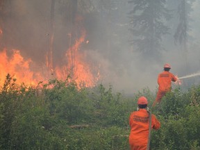 Firefighters battle a wildfire near La Ronge on July 5, 2015.