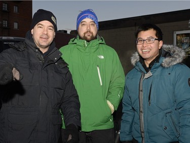 Greg Stephenson, Jason Powell and Mike Wong wait on the sidewalk to buy mead at Bushwakker Brewpub in Regina, Sask. on Saturday Dec. 5, 2015.