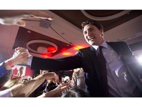 Liberal leader and Prime Minister Elect Justin Trudeau shakes hands as he leaves following his victory speech at Liberal party headquarters in Montreal on Monday, Oct. 19, 2015 after winning the 42nd Canadian general election.