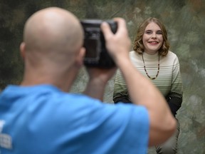 Melissa Alexander, right, smiles for Ron Gergely's camera, left, at the Help-Portrait Regina event held at the Saskatchewan Abilities Council in Regina, Sask. on Saturday Dec. 5, 2015.
