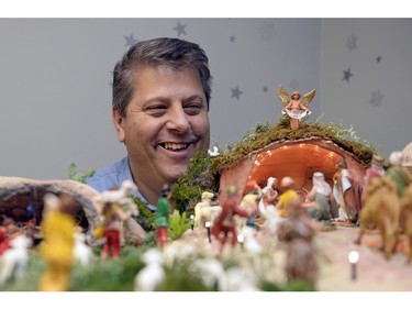 Orazio Giannini with his presepio at his home in Regina. The model illustrates aspects of the Christmas story, set in an Italian context.