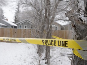 Police tape surrounds a home at 1070 Argyle St. in Regina, Sask. on Sunday December 20, 2015. Police were dispatched to the house on Saturday where they found a deceased male.