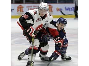 Regina Pats forward Lane Zablocki (#39) battles with Moose Jaw Warriors forward Tanner Jeannot (#10) during a game at the Brandt Centre on Saturday.