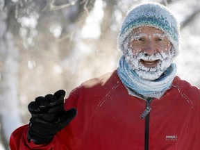 Wilf Ouimet (#3170) waves during a half-marathon during the Hypothermic Run held in Wascana Centre in Regina on Sunday Feb. 22, 2015.