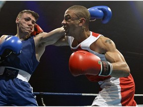 Team Canada's K'dee Warner of Toronto Ont. (red) and Team USA Luis Feliciano of Milwaukee Ws.  battle during their 64 KG bout at the 22nd annual Ken Goff Memorial Boxing Classic in Regina Friday night. Team USA's Feliciano won a split decision.