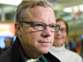 Premier Brad Wall talks to reporters at the Regina airport when he returned from the Paris climate conference on Dec. 3