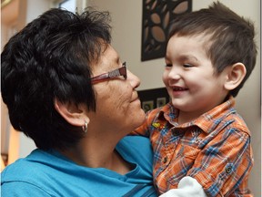 Maxine Goforth holds her grandson KC Goforth after hearing plans for the federal government's inquiry on missing and murdered indigenous women.