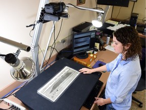 Becky Hahn, an archival imaging technician copying a photo with a digital camera at Saskatchewan Provincial Archives in Regina on December 10, 2015.