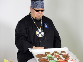 Dickie Yuzicapi,  The Sioux Chef,  with some of his indigenous-themed gingerbread cookies.