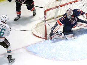 Kelowna Rockets' Cole Linaker, left, puts a shot past Regina Pats goalie Tyler Brown during first-period WHL action Friday at the Brandt Centre.