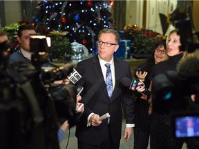 Brad Wall in a scrum with reporters.