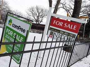 For sale signs on the 200 block of Broadway Avenue East in Regina on Tuesday. Regina home prices are expected to fall in 2016, according to the Conference Board of Canada.