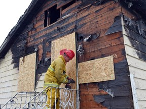 REGINA SK: DECEMBER 24, 2015 -- Investigators on the scene of a house fire at 455 McIntrye Street in Regina on December 24, 2015. Regina Fire and Protective Services responded to a house fire at approximately 1:36 a.m. Thursday morning. No one was home during the fire and no was injured, but the family is now without a home as damages were substantial.