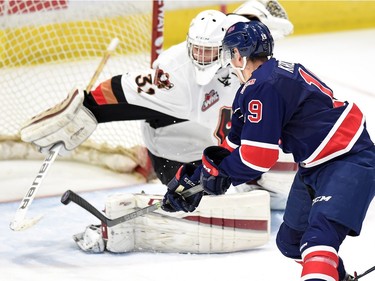 The Regina Pats' Colten Kroeker lifts the puck over Calgary Hitmen netminder Cody Porter for a first-period goal Wednesday at the Brandt Centre.