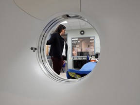 Dr. Andrea Gourgaris, a radiologist at Radiology Associates of Regina, demonstrates a CT scanner in Regina on Monday.