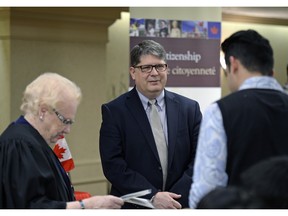 Presiding official M. Isabelle Butters (left) and Michael Boda, (centre) Saskatchewan's chief electoral officer, participated as new Canadians were welcomed during a citizenship ceremony.