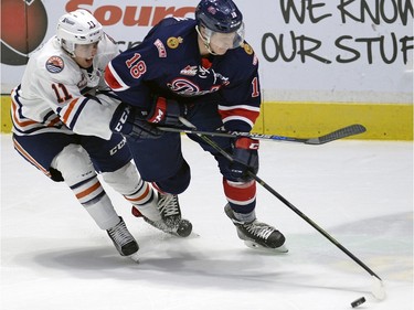 Blazers Erik Miller 11 and Pats Aaron Macklin 18 tangle up during WHL action between the Regina Pats and the Kamloops Blazers at the Brandt Centre.