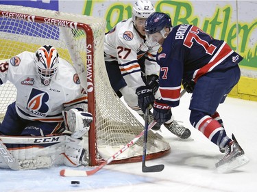 Pats Adam Brooks 77 is tied up by Blazers Nolan Kneen 27as he tries a wrap around on Blazers goal tender Connor Ingram 39 during WHL action between the Regina Pats and the Kamloops Blazers at the Brandt Centre.