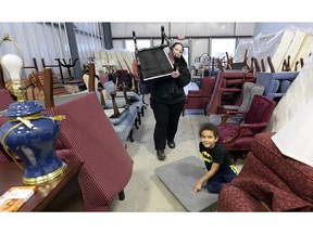 Six-year-ld Tariq Head-Sabtiu looks on as mom Helen moves furniture being sold from the Hotel Saskatchewan -– a sale occasioned by renovations to the historic downtown hotel.