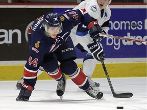 Regina Pats defenceman Connor Hobbs, left, gets away from the Saskatoon Blades' Cameron Hebig during WHL action at the Brandt Centre on Friday.