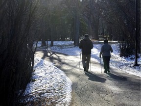 A couple enjoy a walk through wascana Park with their ski poles but no cross country skis due to a lack of snow December 3, 2015.