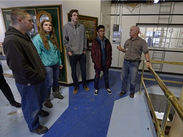 Douglas Elder (right) of the Ministry of Government Services explains the workings of the plant to Saskatchewan students.