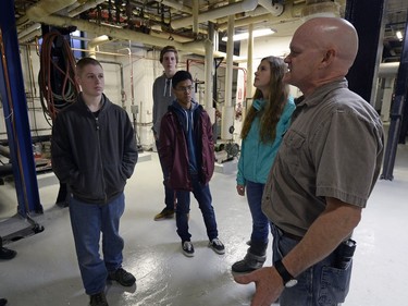 Douglas Elder (right) of the Ministry of Government Services explains the workings of the plant to Saskatchewan students.